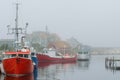 Red Boats in Foggy Harbor Royalty Free Stock Photo