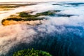 Foggy landscape. Aerial scenery. Blue lakes and green forest view at sunrise