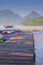 Foggy landscape with calm lake and pier.Mist over water. Beautiful freedom moment and peaceful atmosphere in nature Royalty Free Stock Photo