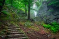 A foggy landscape of stairs from hellish Valley to Chojnik Castle in the Karkonosze Mountains. Poland