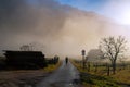 Countryside misty landscape with person silhouette walking alone on the foggy walkway Royalty Free Stock Photo