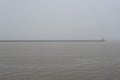 Foggy, misty and cloudy grey seascape with horizon at the sea or ocean Royalty Free Stock Photo