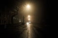 Foggy misty night road illuminated by street lights Royalty Free Stock Photo