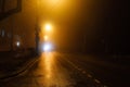 Foggy misty night road illuminated by street lights Royalty Free Stock Photo