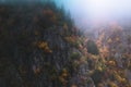 Foggy and moody scenery in the Vosges mountains, France. Colorful trees and rocky cliff landscape Royalty Free Stock Photo