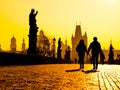 Foggy morning on Charles Bridge, Prague, Czech Republic. Sunrise with silhouettes of walking people, statues and Old Royalty Free Stock Photo