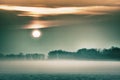 Foggy morning in the country side, orange sky, Czech Republic