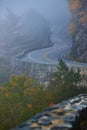 Foggy morning detail of winding road through cliffs with beautiful stone wall Royalty Free Stock Photo