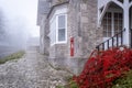 Foggy morning in English village with touch of red Royalty Free Stock Photo