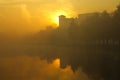 Foggy morning over the lake, fall trees reflected in water Royalty Free Stock Photo