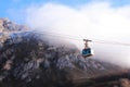 Cable car climbing up on mountain stock photo