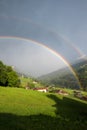 Foggy mountain landscape with double rainbow and view to prattigau valley switzerland