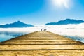 Foggy mountain landscape with seagulls on Pier of lake Mondsee i Royalty Free Stock Photo