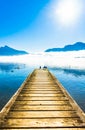 Foggy mountain landscape with seagulls on Pier of lake Mondsee i Royalty Free Stock Photo