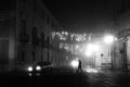 Foggy night scene with solitary man and christmas light decorations Royalty Free Stock Photo
