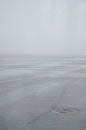 Foggy overlay on the airport runway. Bad weather overcast. Iron sewer hatch and asphalt on runway are very icy Royalty Free Stock Photo