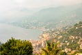 Foggy panoramic view of Ligurian coastline landscape. Graduated green mountain chains full of small towns and villages. Liguria is Royalty Free Stock Photo