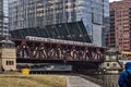 Foggy, rainy afternoon in downtown Chicago, as elevated `el` train transfers commuters across the Chicago River Royalty Free Stock Photo