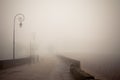 Foggy road with old lamps Royalty Free Stock Photo