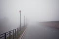 Foggy road with old lamps Royalty Free Stock Photo