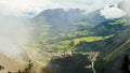 Foggy scene of Hohenwerfen castle among mountain ranges, Austria