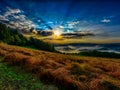 Foggy scenic glorious epic sunrise landscape panorama with valleys and hills