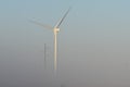 Foggy South Texas wind turbine and power pole