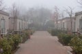 Foggy street among camp houses