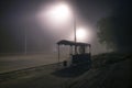 Foggy street lights misty with night deserted road