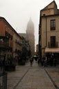 foggy street in Salamanca with the cathedral tower in the background