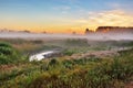 Foggy summer meadow in the morning. Misty dawn panorama. Royalty Free Stock Photo