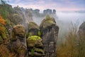 Foggy sunrise at Bastei Saxon Switzerland National Park, Germany, Basteiaussicht or Bastei