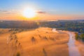 Foggy sunrise over the countryside, fog in the lowlands over the flooded swamps along the river. Landshat aerial view Royalty Free Stock Photo