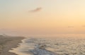 Foggy sunrise over the sea. Pastel shades. Beautiful landscape. Sandy beach of the ocean. Sunset sky. Clouds. Coast Royalty Free Stock Photo