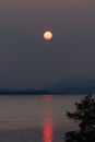 Foggy sunset with boat in British Columbia after wildfire Royalty Free Stock Photo