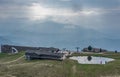 Foggy top of Monte Tamaro, with lake, restaurant and red brick chapel Santa Maria degli Angeli Royalty Free Stock Photo