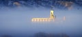 Foggy Valley in City with Granary or Grainary in Golden Sunlight