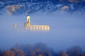 Foggy Valley in City with Granary or Grainary in Golden Sunlight