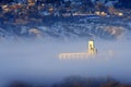 Foggy Valley in City with Granary or Grainary in Golden Sunlight