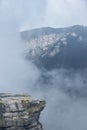 Foggy valley with cliff rock