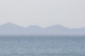 Foggy View of Mountains Across from the Ocean