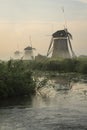 Foggy windmills on a Royalty Free Stock Photo