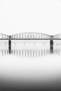 Foggy winter mood at Vltava river. Reflection of bridges in water. Black and white atmosphere, Prague, Czech republic Royalty Free Stock Photo