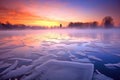 foggy winter sunrise over a frozen lake