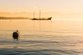 Foggy Winter Sunrise over Lake Leman and Boat Royalty Free Stock Photo