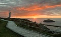 Foghorn and wooden walkway near lighthouse PeÃÂ±as Cape on a beautiful sunset Coast of Asturias, Spain Royalty Free Stock Photo