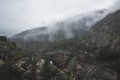 Fogs Among Trees, Dam, and Mountains on a Rainy Day in Hetch Hetchy Reservoir Area in Yosemite National Park, California Royalty Free Stock Photo
