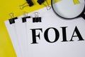 foia concept word written on white paper and yellow background with magnifier. text