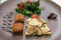 Foie gras appetizer with slices of black truffle and a green salad at a luxury restaurant in Nice, France Royalty Free Stock Photo