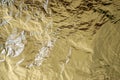 Foil abstract with tones of gold and flashes of silver reflections Royalty Free Stock Photo